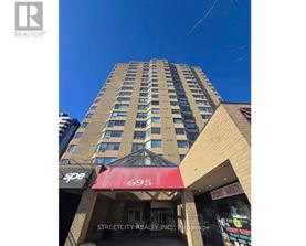 A tall building with a red awning and the number 695 on it.