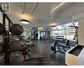 A gym with a variety of equipment including weights and weight machines.