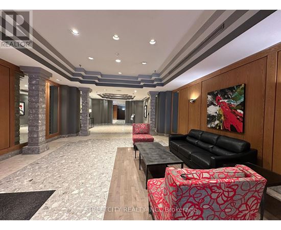 A hallway with a rug and pillars.