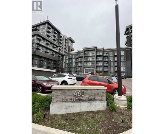 A sign in front of a parking lot reads 460 Dundas Street East.