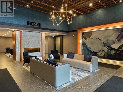 A modern living room with a fireplace and a large painting on the wall.