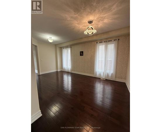 A room with wooden floors and a chandelier.