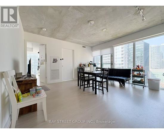 A living room with a dining table and chairs.