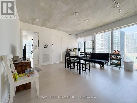 A living room with a dining table and chairs.