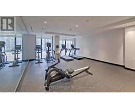 A gym with a variety of equipment including treadmills, stationary bikes, and weight machines.