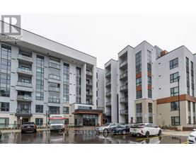 Apartment complex with cars parked in front.