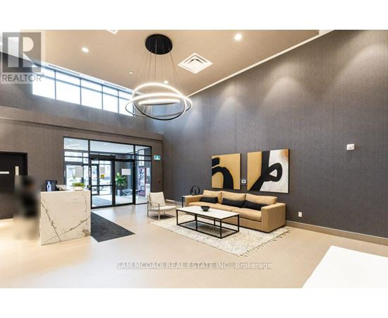 A modern living room with a large painting on the wall and a coffee table in the center.