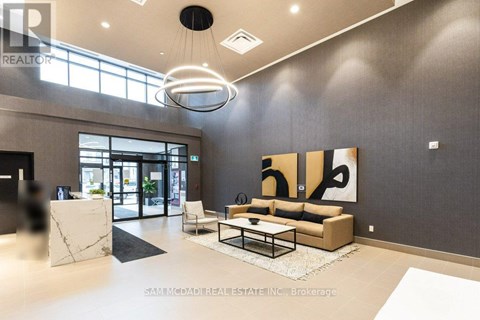 A modern living room with a large painting on the wall and a coffee table in the center.