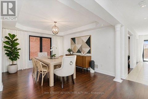 A dining room with a wooden table and chairs.