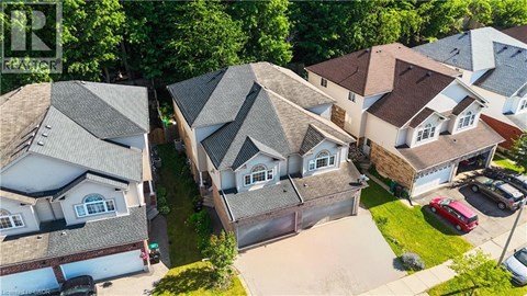 A bird's eye view of a residential area with houses and cars.