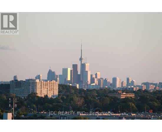 A city skyline with a tall building in the center.