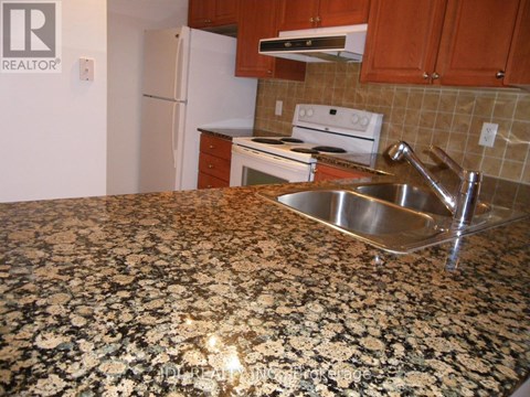 A kitchen with granite countertops and stainless steel appliances.