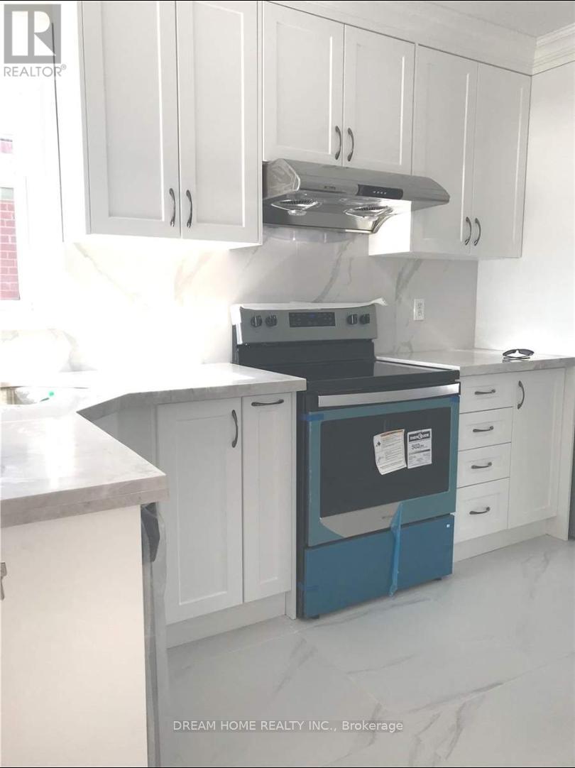 A kitchen with white cabinets and a blue dishwasher.