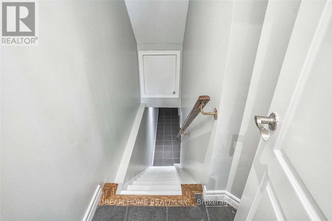 A hallway with a white door and a tiled floor.