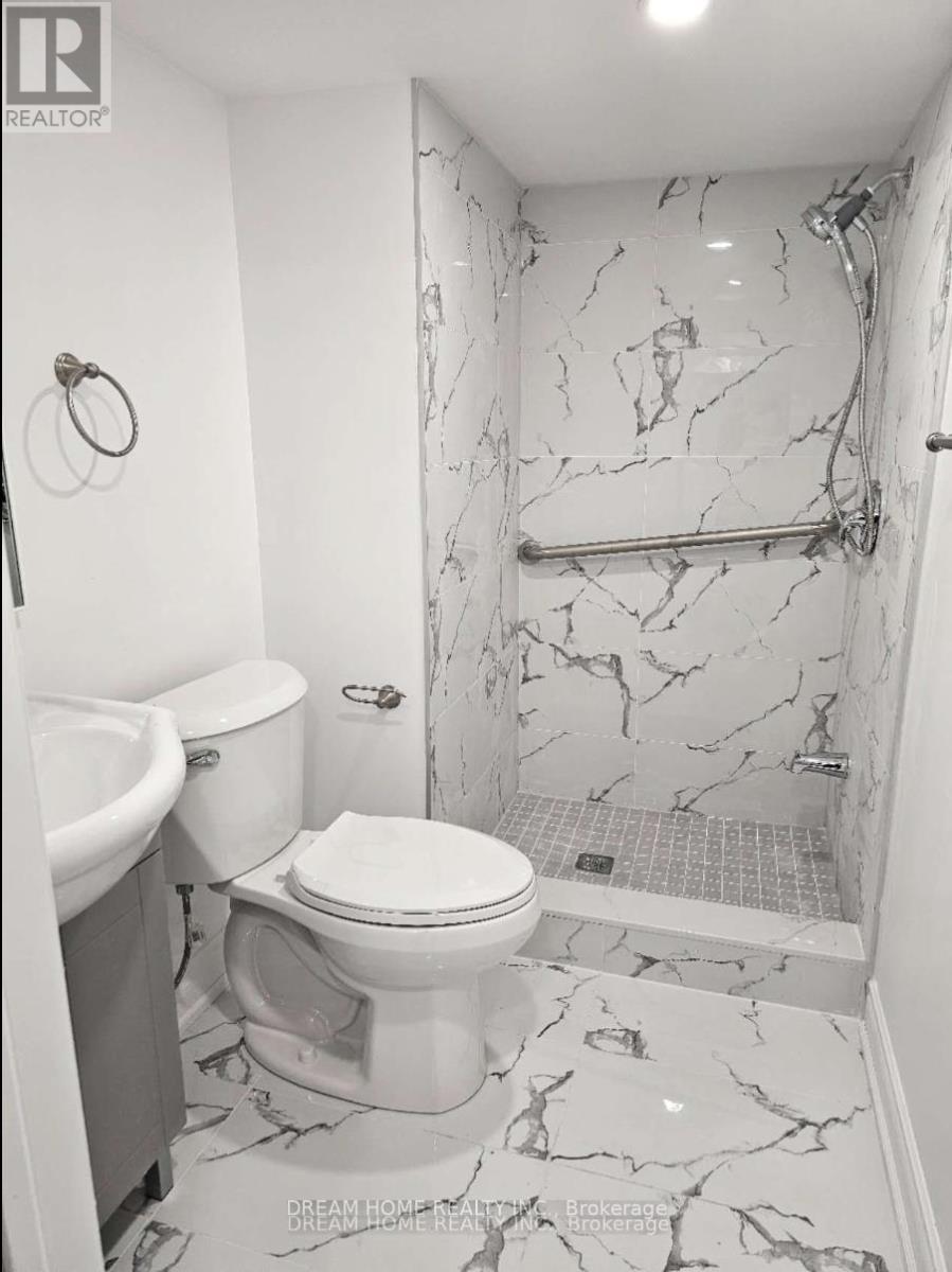A bathroom with a marble floor and walls.