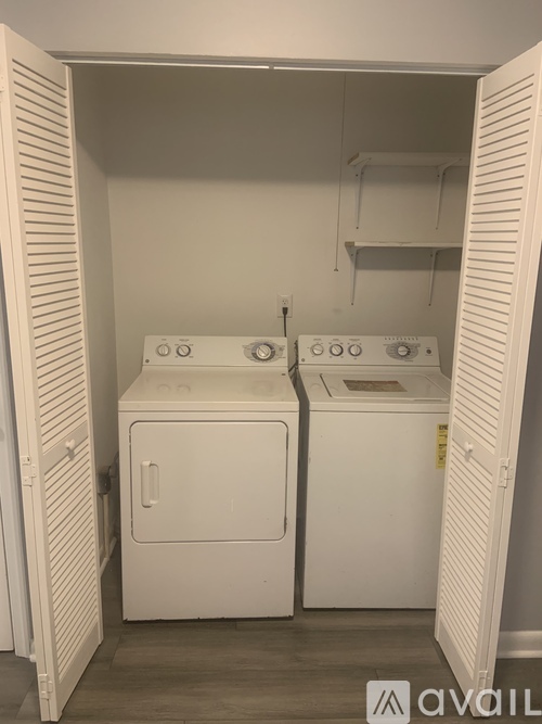 A small laundry room with a washer and dryer.