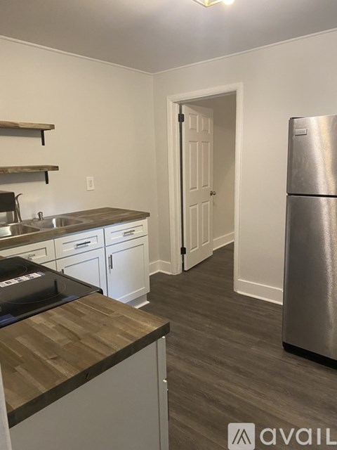 A kitchen with a stove top oven and a refrigerator.