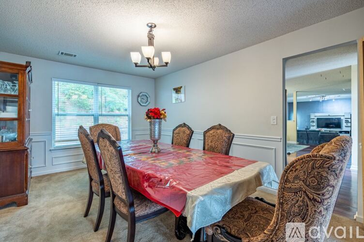 A dining room with a table set for six.