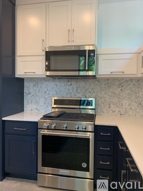 A kitchen with a stainless steel oven and microwave above it.
