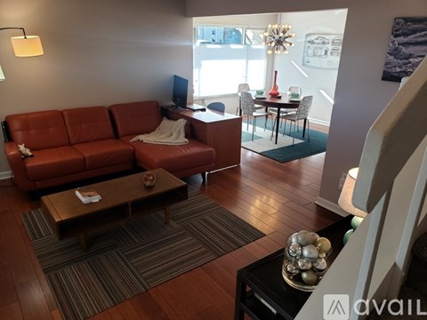 A living room with a red couch and a coffee table.