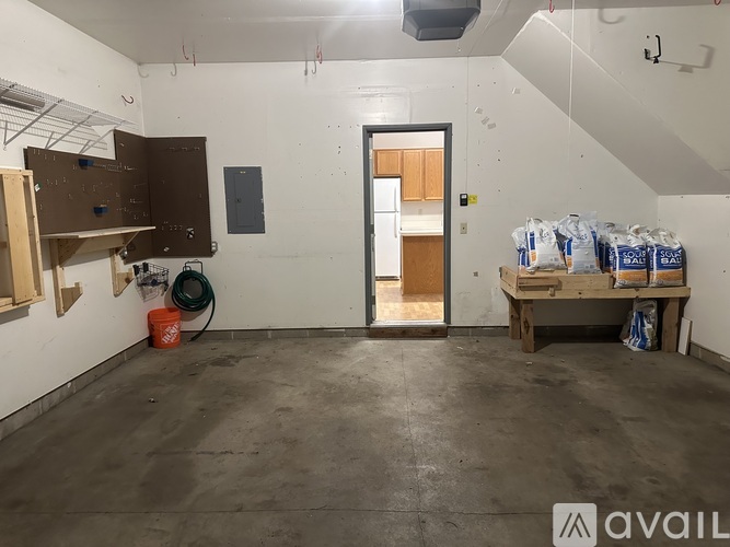 A room with a door, a table, and bags of material on the table.