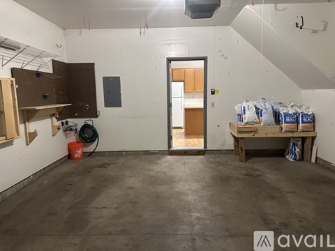 A room with a door, a table, and bags of material on the table.