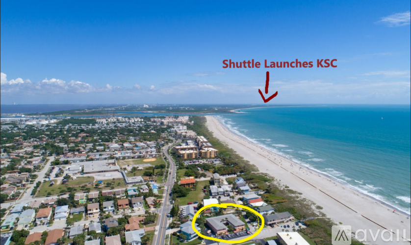 A shuttle launches from a building on a beach.