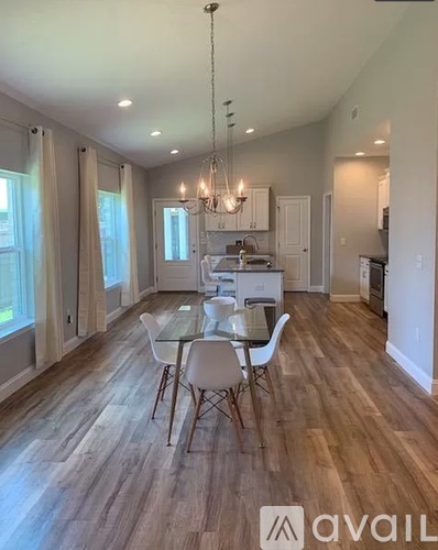 A dining room with a glass table and chairs.