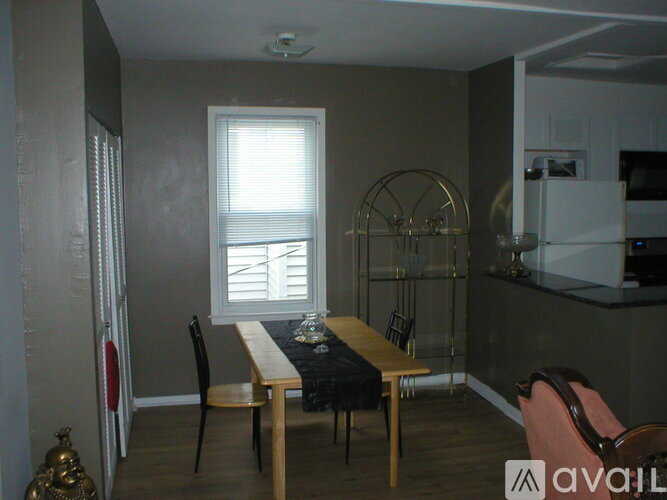 A dining area with a table and chairs.