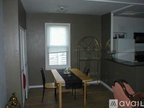A dining area with a table and chairs.