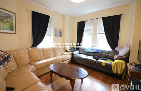 A living room with a leather couch and a coffee table.