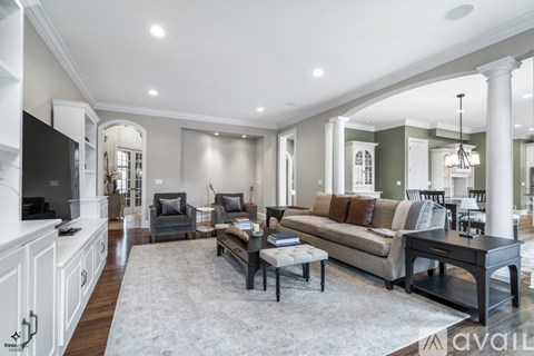 A spacious living room with a grey sofa and a coffee table.