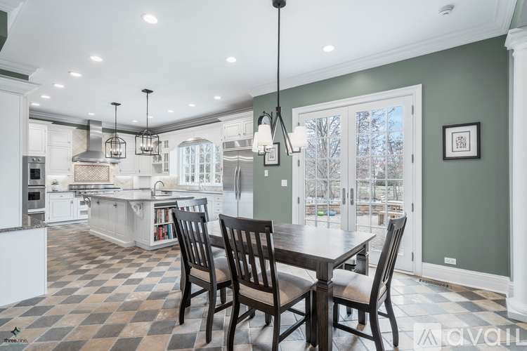 A kitchen with a checkered floor and a dining table with chairs.