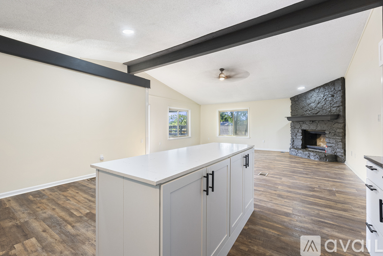 A spacious living room with a fireplace and built-in cabinets.