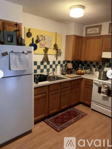 A kitchen with wooden cabinets and a checkered backsplash.