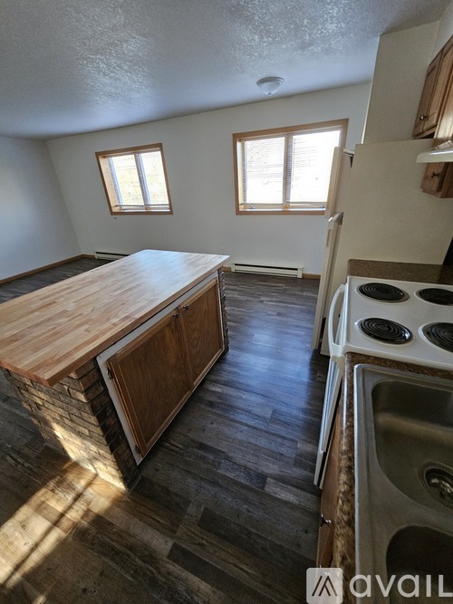 A kitchen with a wooden countertop and a stove top oven.