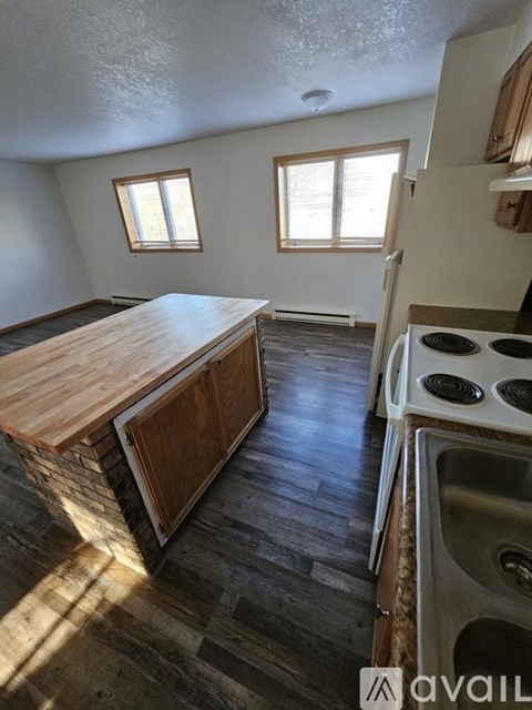 A kitchen with a wooden countertop and a stove top oven.