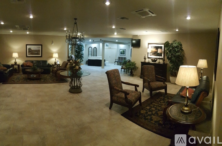 A living room with a chandelier, couches, and a coffee table.