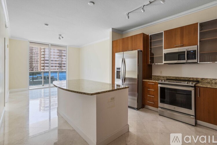 A kitchen with a white countertop and stainless steel appliances.