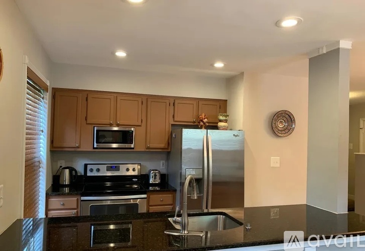 A kitchen with a stove, oven, and refrigerator.