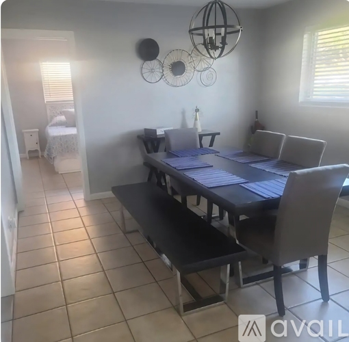 A dining room with a table and chairs.
