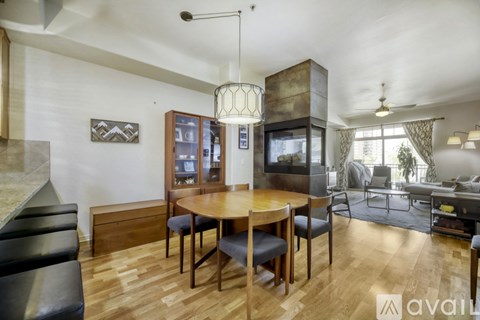 A modern living room with a wooden table and chairs.