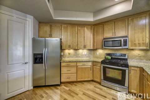 A kitchen with wooden cabinets and stainless steel appliances.