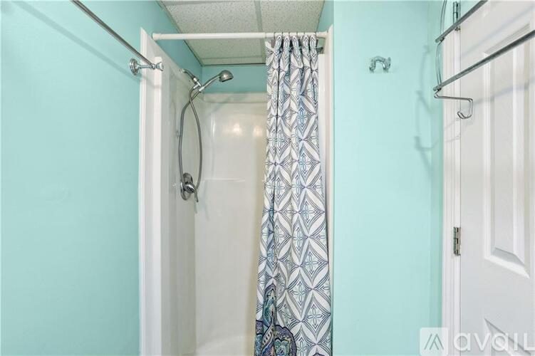 A bathroom with a blue wall and a white door.