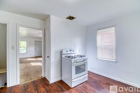 A kitchen with a stove and a window.