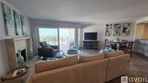 A living room with a fireplace and a large couch.