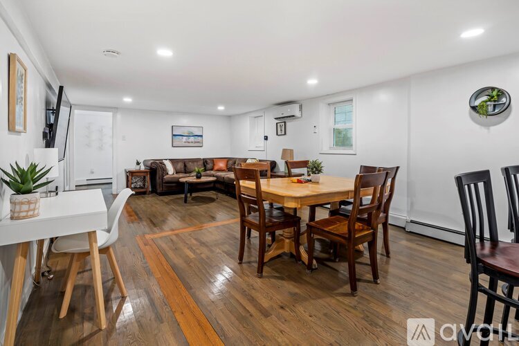 A dining room with a wooden table and chairs.