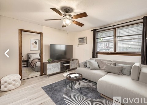A living room with a television, couch, and a coffee table.