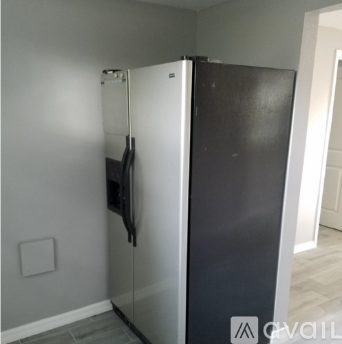 A black and white fridge in a kitchen.