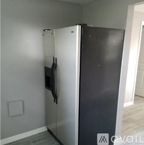 A black and white fridge in a kitchen.